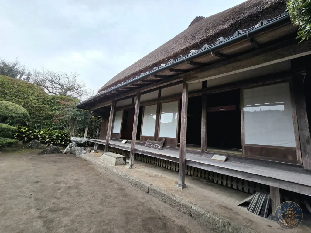 Traditional thatched-roof Futatsuya Samurai House with wooden engawa veranda in the historic Chiran Samurai District. Beautifully preserved Edo-period architecture and garden setting in Kagoshima, Japan. Kagoshima Cruise Port Guide | Things to do in Kagoshima from cruise ship | One day in Kagoshima Japan itinerary by Danny and Peter.