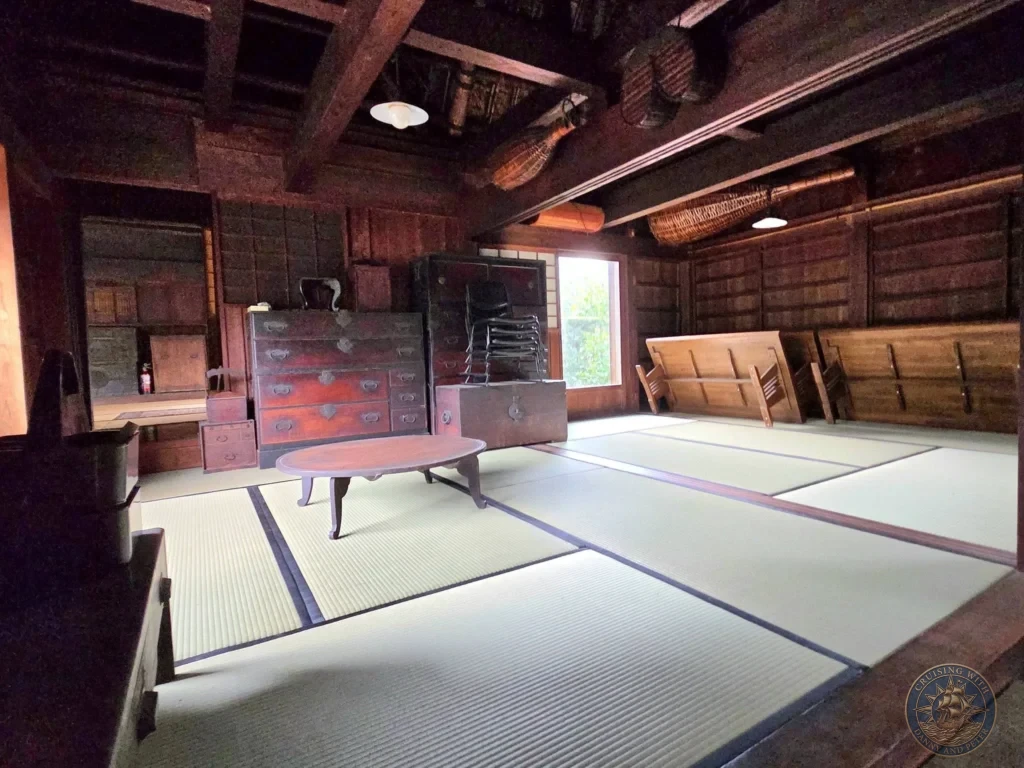 Traditional interior of the Futatsuya Samurai House in Chiran Samurai District featuring spacious tatami mat rooms, antique wooden furniture, and classic dark wood architecture. Authentic Edo-period samurai home in Kagoshima, Japan. Kagoshima Cruise Port Guide | Things to do in Kagoshima from cruise ship | One day in Kagoshima Japan itinerary by Danny and Peter.