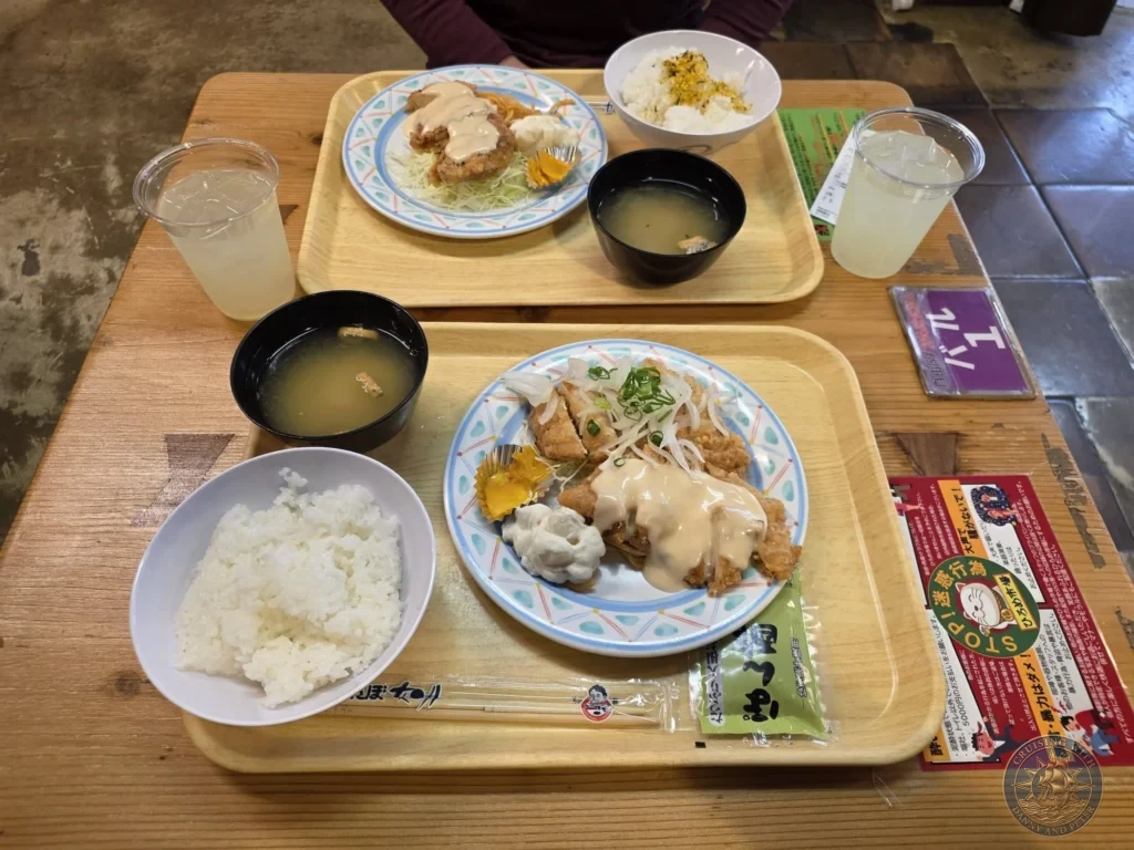 Tasty Japanese meal trays featuring chicken katsu with rice, miso soup, and drinks at Hirome Market in Kochi, Japan. Popular local food court dishes. Kochi Cruise Port Guide | Things to do in Kochi from cruise ship | One day in Kochi Japan itinerary by Danny and Peter.