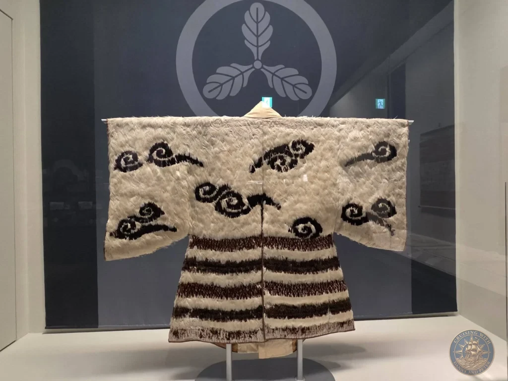 Unique traditional feathered or fiber robe on display at the Kochi Museum of History in Kochi, Japan. Important cultural artifact. Kochi Cruise Port Guide | Things to do in Kochi from cruise ship | One day in Kochi Japan itinerary by Danny and Peter.