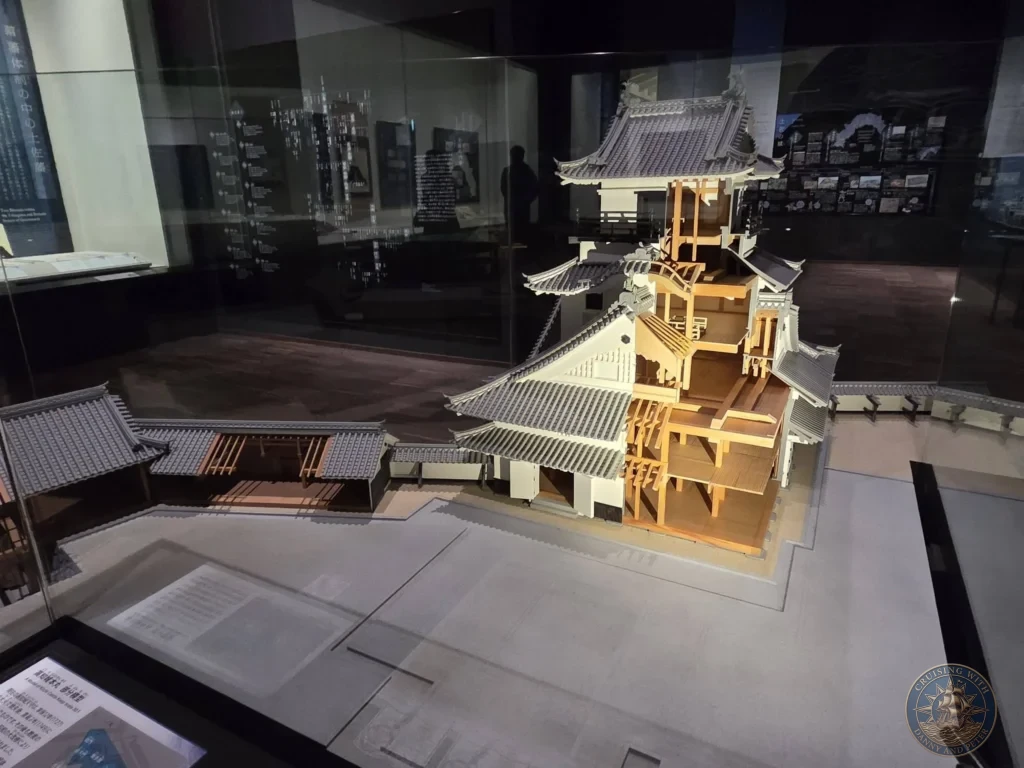 Detailed cutaway architectural model of a traditional Japanese building at the Kochi Museum of History in Kochi, Japan. Educational exhibit on historic architecture. Kochi Cruise Port Guide | Things to do in Kochi from cruise ship | One day in Kochi Japan itinerary by Danny and Peter.