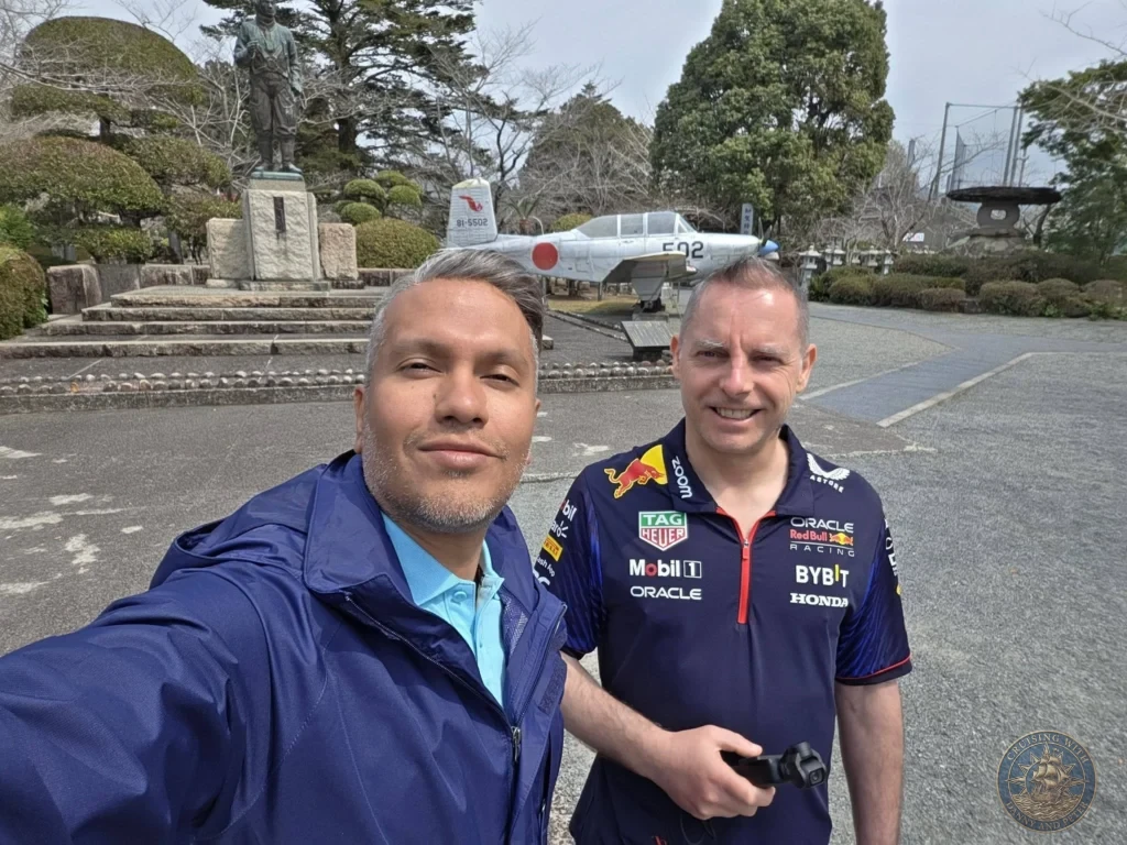 Danny and Peter taking a selfie at the Chiran Peace Museum for Kamikaze Pilots, with the pilot statue and historic aircraft on display in the background. Sobering and educational stop near the Chiran Samurai District in Kagoshima, Japan. Kagoshima Cruise Port Guide | Things to do in Kagoshima from cruise ship | One day in Kagoshima Japan itinerary by Danny and Peter.