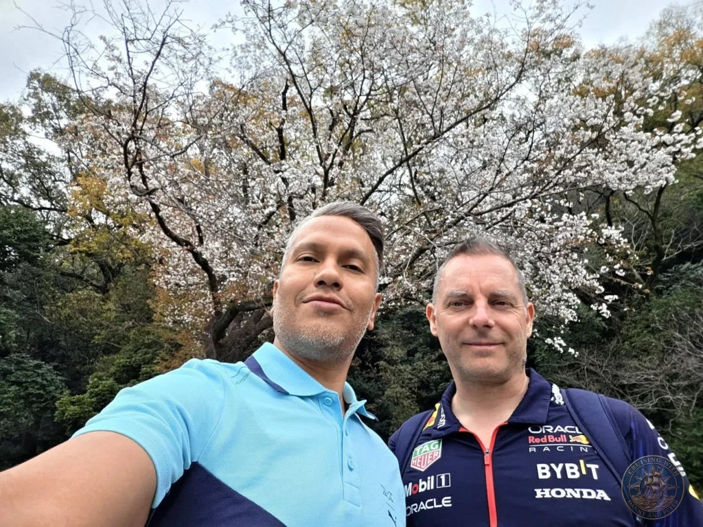 Danny and Peter taking a selfie under beautiful blooming cherry blossom trees at Sengan-en (Iso Garden) in Kagoshima, Japan. Iconic spring scenery at the historic samurai garden with Sakurajima views. Kagoshima Cruise Port Guide | Things to do in Kagoshima from cruise ship | One day in Kagoshima Japan itinerary by Danny and Peter.