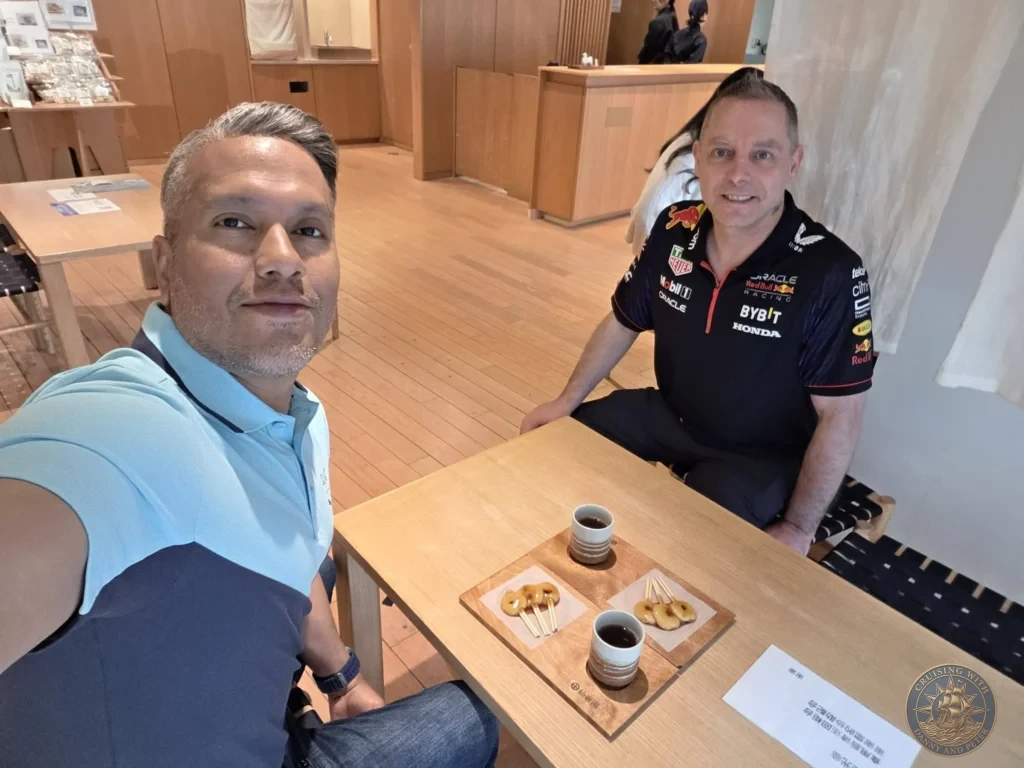 Danny and Peter enjoying traditional mitarashi dango and green tea at Sengan-en (Iso Garden) café in Kagoshima. Relaxing break inside the historic UNESCO World Heritage garden with cherry blossoms nearby. Kagoshima Cruise Port Guide | Things to do in Kagoshima from cruise ship | One day in Kagoshima Japan itinerary by Danny and Peter.