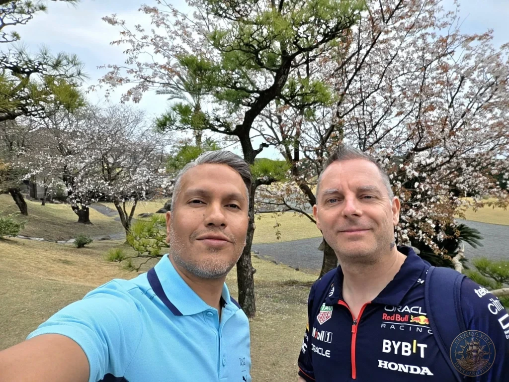 Danny and Peter taking a selfie under blooming cherry blossom trees at Sengan-en (Iso Garden) in Kagoshima, Japan. Stunning spring scenery at the historic UNESCO World Heritage samurai garden with traditional pines and landscaped grounds. Kagoshima Cruise Port Guide | Things to do in Kagoshima from cruise ship | One day in Kagoshima Japan itinerary by Danny and Peter.