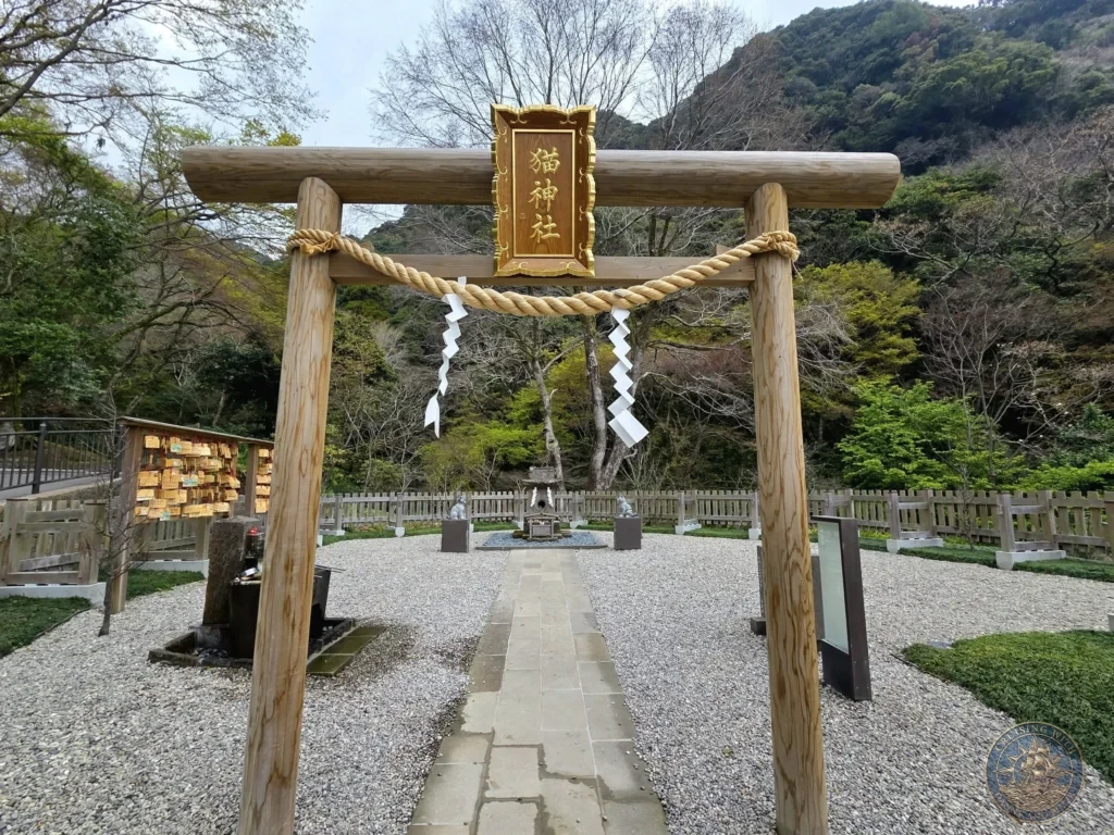 Wooden torii gate with shimenawa rope marking the entrance to Neko Jinja (Cat Shrine) at Sengan-en (Iso Garden), the historic UNESCO World Heritage samurai villa in Kagoshima, Japan. Charming spiritual spot within the beautiful garden. Kagoshima Cruise Port Guide | Things to do in Kagoshima from cruise ship | One day in Kagoshima Japan itinerary by Danny and Peter.