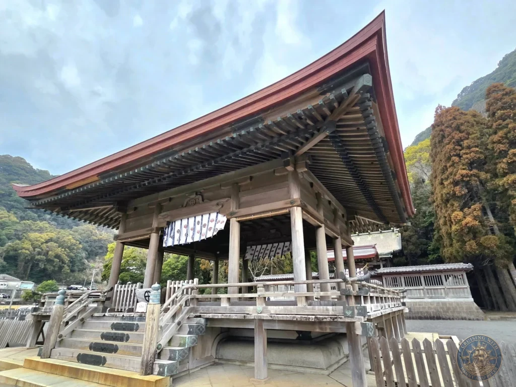 Historic Tsurugane Shrine with traditional wooden architecture and distinctive red roof at Sengan-en (Iso Garden), the UNESCO World Heritage samurai villa in Kagoshima, Japan. Beautiful shrine nestled within the scenic garden grounds. Kagoshima Cruise Port Guide | Things to do in Kagoshima from cruise ship | One day in Kagoshima Japan itinerary by Danny and Peter.