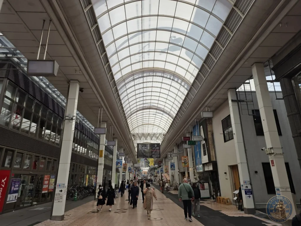 Long covered shopping arcade in Kochi, Japan. Pedestrian street with shops under a glass roof. Kochi Cruise Port Guide | Things to do in Kochi from cruise ship | One day in Kochi Japan itinerary by Danny and Peter.