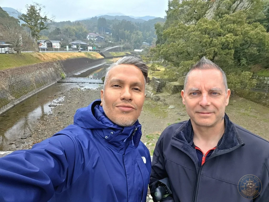 Danny and Peter taking a selfie at Chiran Samurai District near Garden 7 (Mori Shigemitsu Garden), the only Tsukiyama Sensui pond garden in the historic samurai village. Scenic river valley and mountain views in Kagoshima, Japan. Kagoshima Cruise Port Guide | Things to do in Kagoshima from cruise ship | One day in Kagoshima Japan itinerary by Danny and Peter.