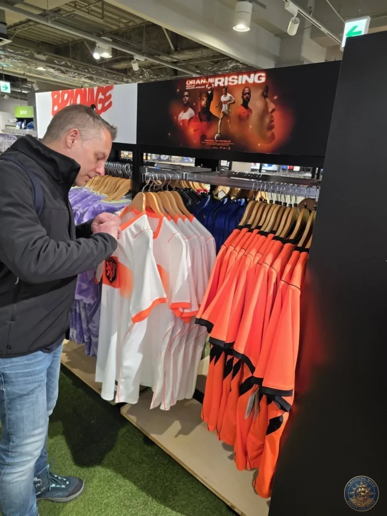 Browsing Netherlands national team soccer jerseys in a shop at Canal City Hakata, Fukuoka, Japan. Cruise port shopping. Fukuoka Cruise Port Guide | Things to do in Fukuoka from cruise ship | One day in Fukuoka Japan itinerary by Danny and Peter.