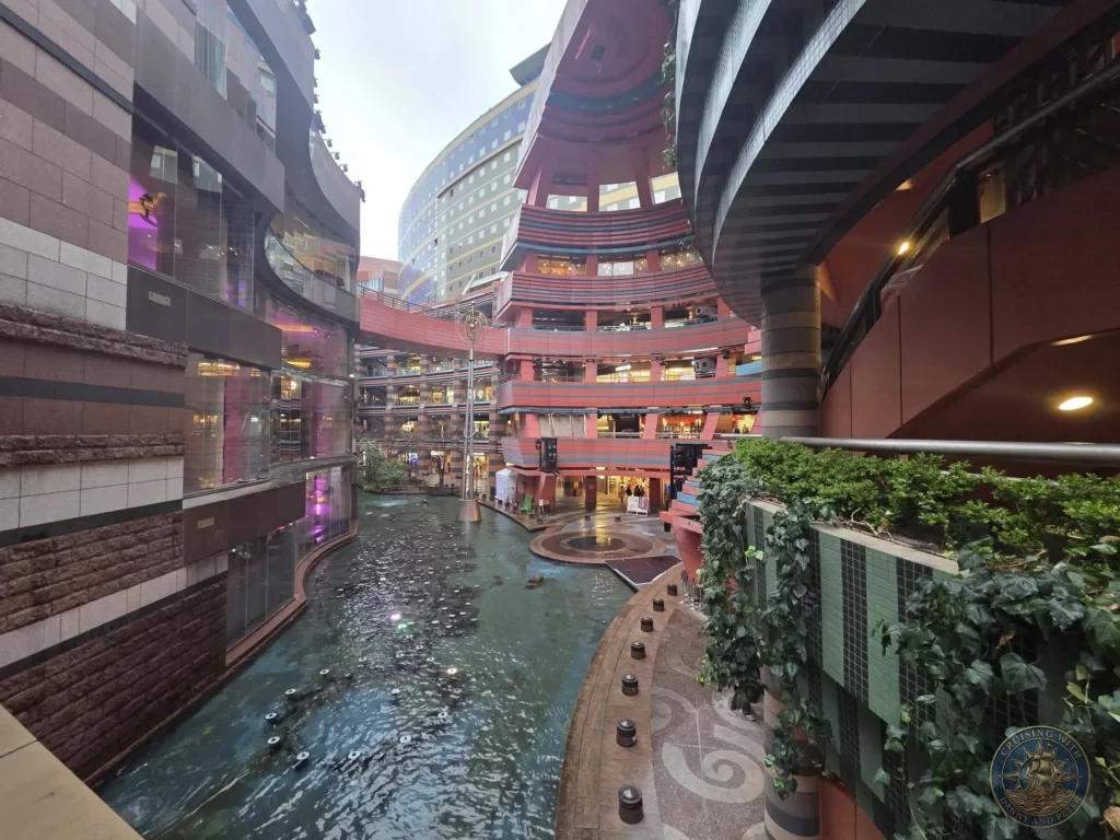 Canal winding through the multi-level architecture at Canal City Hakata in Fukuoka, Japan. Shopping and entertainment complex. Fukuoka Cruise Port Guide | Things to do in Fukuoka from cruise ship | One day in Fukuoka Japan itinerary by Danny and Peter.