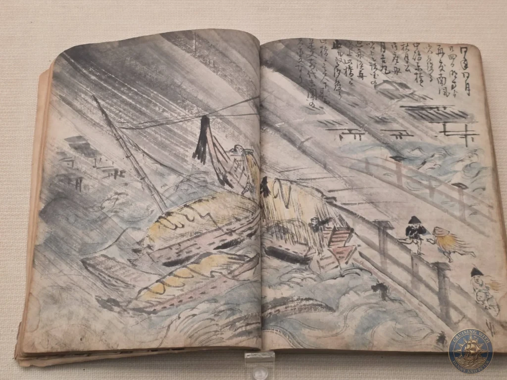 Open antique Japanese book showing dramatic illustration of boats in rough seas at Fukuoka City Museum, Japan. Historical maritime art. Fukuoka Cruise Port Guide | Things to do in Fukuoka from cruise ship | One day in Fukuoka Japan itinerary by Danny and Peter.