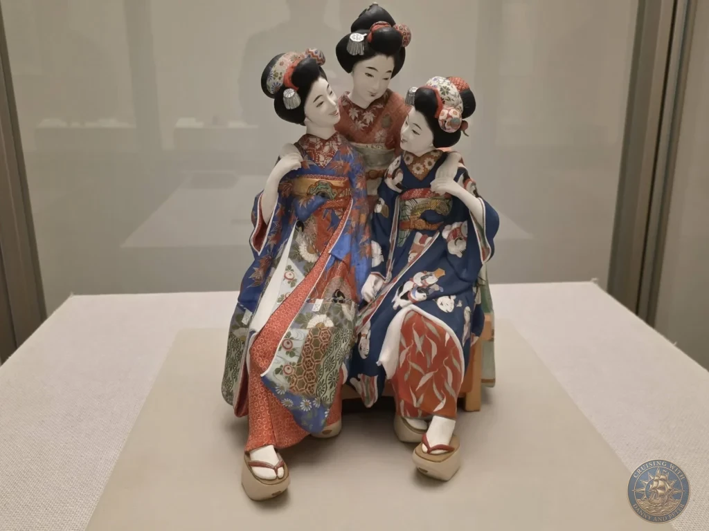 Three beautiful traditional Japanese dolls in colorful kimonos displayed at Fukuoka City Museum, Japan. Cultural artifacts. Fukuoka Cruise Port Guide | Things to do in Fukuoka from cruise ship | One day in Fukuoka Japan itinerary by Danny and Peter.