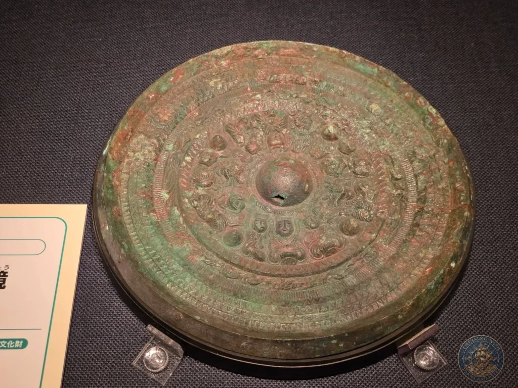 Intricately decorated ancient bronze mirror exhibited at Fukuoka City Museum in Japan. Archaeological artifact. Fukuoka Cruise Port Guide | Things to do in Fukuoka from cruise ship | One day in Fukuoka Japan itinerary by Danny and Peter.