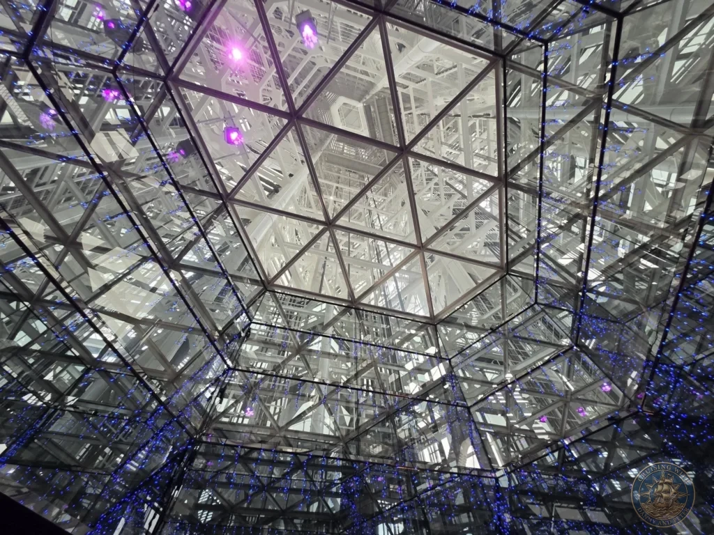 Reflective mirrored ceiling with glowing blue and purple lights at Fukuoka Tower observation deck, Japan. Iconic interior view. Fukuoka Cruise Port Guide | Things to do in Fukuoka from cruise ship | One day in Fukuoka Japan itinerary by Danny and Peter.