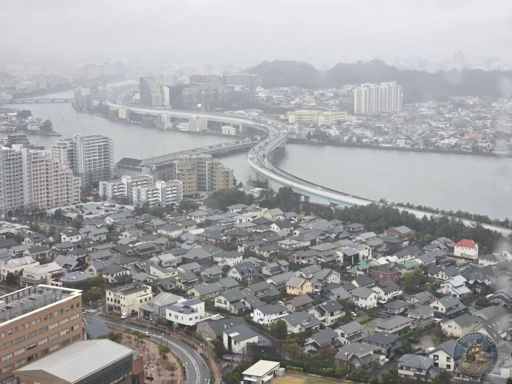 Panoramic foggy cityscape from Fukuoka Tower showing river, elevated highway and urban buildings in Fukuoka, Japan. Landmark overlook. Fukuoka Cruise Port Guide | Things to do in Fukuoka from cruise ship | One day in Fukuoka Japan itinerary by Danny and Peter.