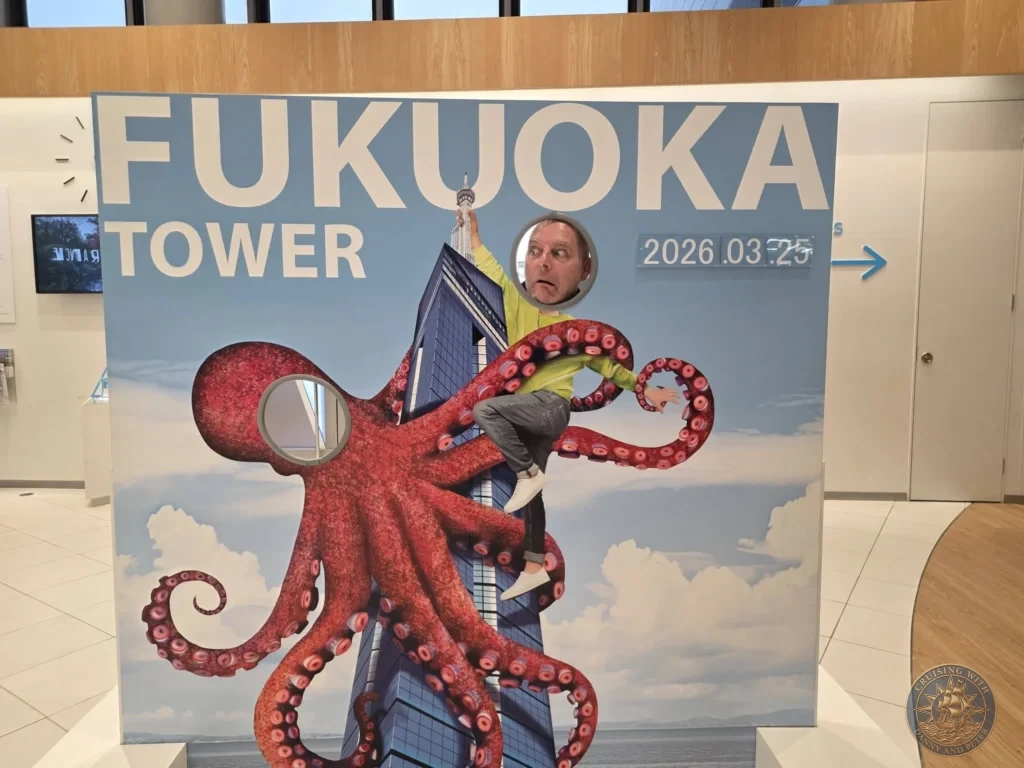 Peter with his head through the fun octopus cutout photo prop at Fukuoka Tower, Japan. Playful souvenir. Fukuoka Cruise Port Guide | Things to do in Fukuoka from cruise ship | One day in Fukuoka Japan itinerary by Danny and Peter.