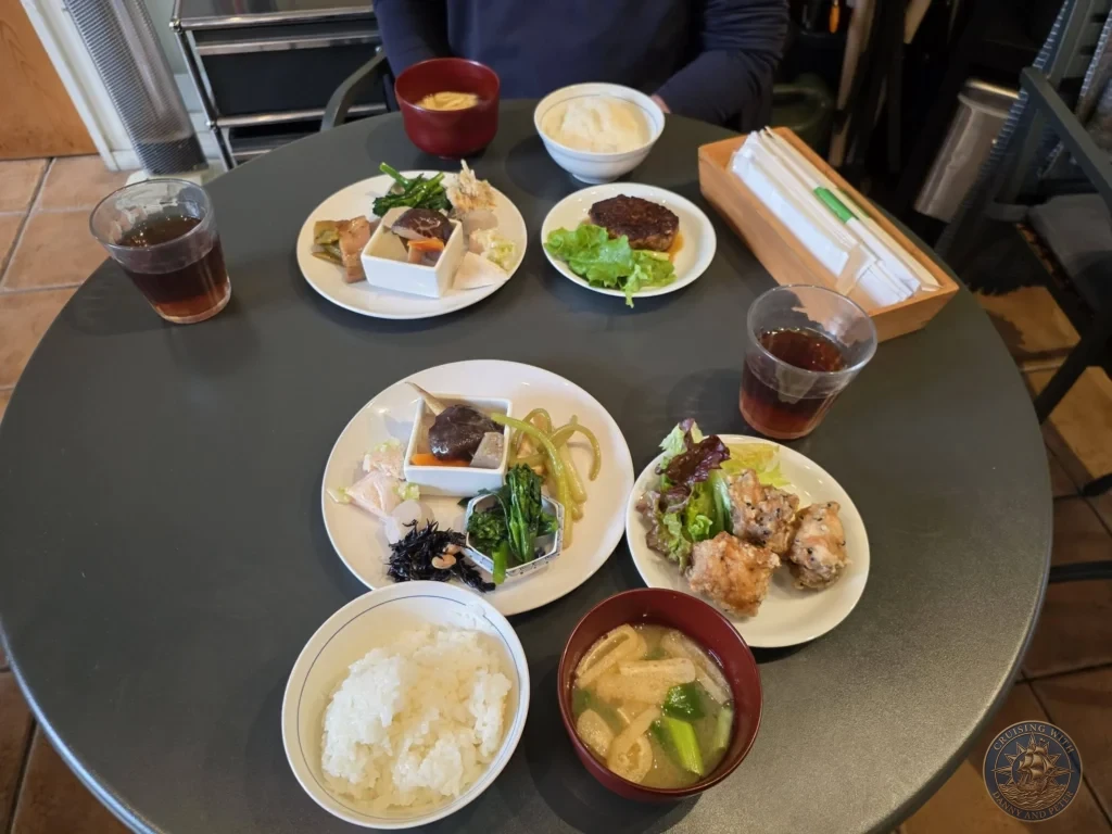 Colorful traditional Japanese lunch set with rice, soup, and assorted side dishes on a round table in Fukuoka, Japan. Local restaurant meal. Fukuoka Cruise Port Guide | Things to do in Fukuoka from cruise ship | One day in Fukuoka Japan itinerary by Danny and Peter.