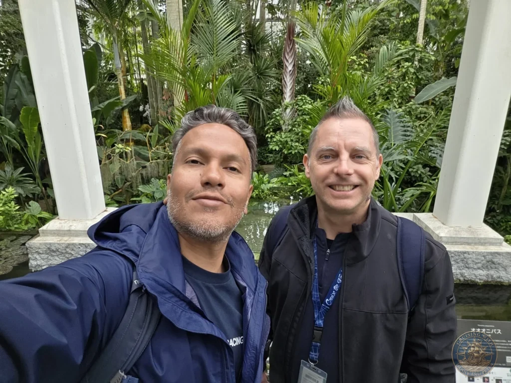 Danny and Peter taking a selfie amid lush greenery at Makino Botanical Garden in Kochi, Japan. Tropical plants and greenhouse setting. Kochi Cruise Port Guide | Things to do in Kochi from cruise ship | One day in Kochi Japan itinerary by Danny and Peter.
