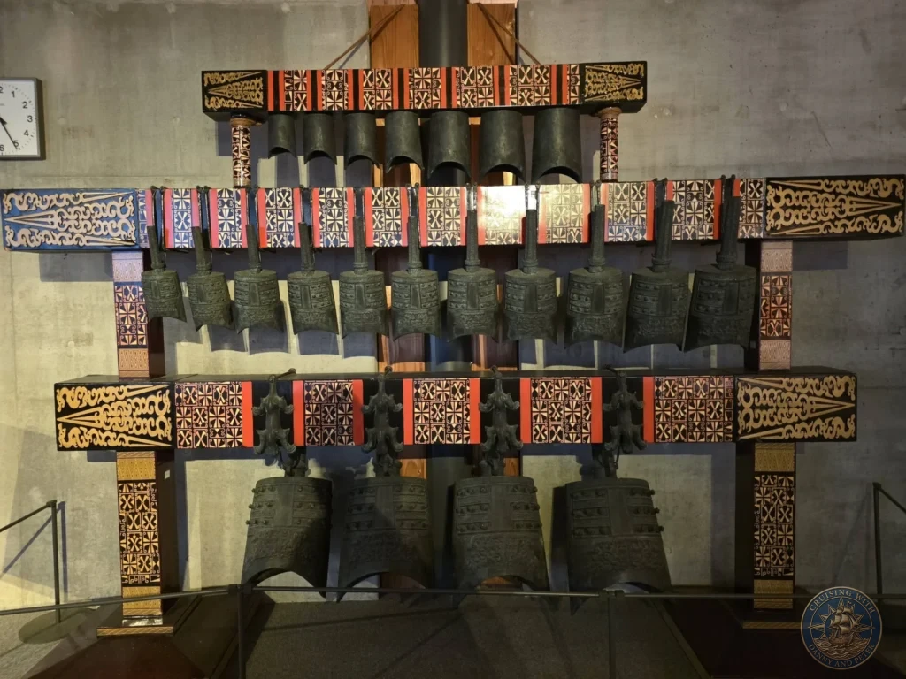 Set of historic bronze bells on ornate display at the Kochi Museum of History in Kochi, Japan. Traditional Japanese artifacts. Kochi Cruise Port Guide | Things to do in Kochi from cruise ship | One day in Kochi Japan itinerary by Danny and Peter.
