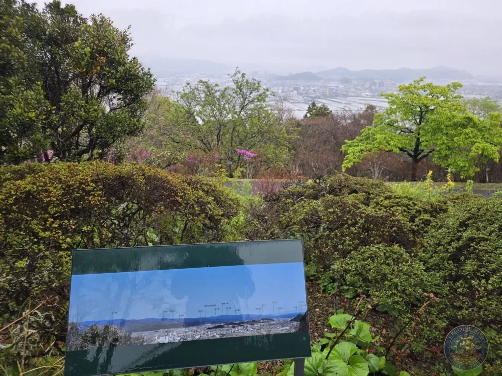 Sweeping panoramic view of Kochi city and mountains from Makino Botanical Garden in Kochi, Japan. Scenic overlook with information panel. Kochi Cruise Port Guide | Things to do in Kochi from cruise ship | One day in Kochi Japan itinerary by Danny and Peter.