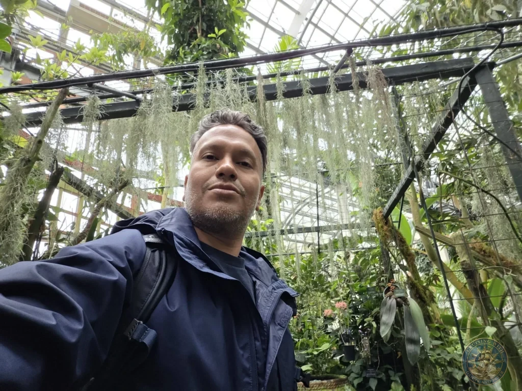 Danny taking a selfie in the lush greenhouse filled with hanging air plants at Makino Botanical Garden in Kochi, Japan. Tropical conservatory. Kochi Cruise Port Guide | Things to do in Kochi from cruise ship | One day in Kochi Japan itinerary by Danny and Peter.
