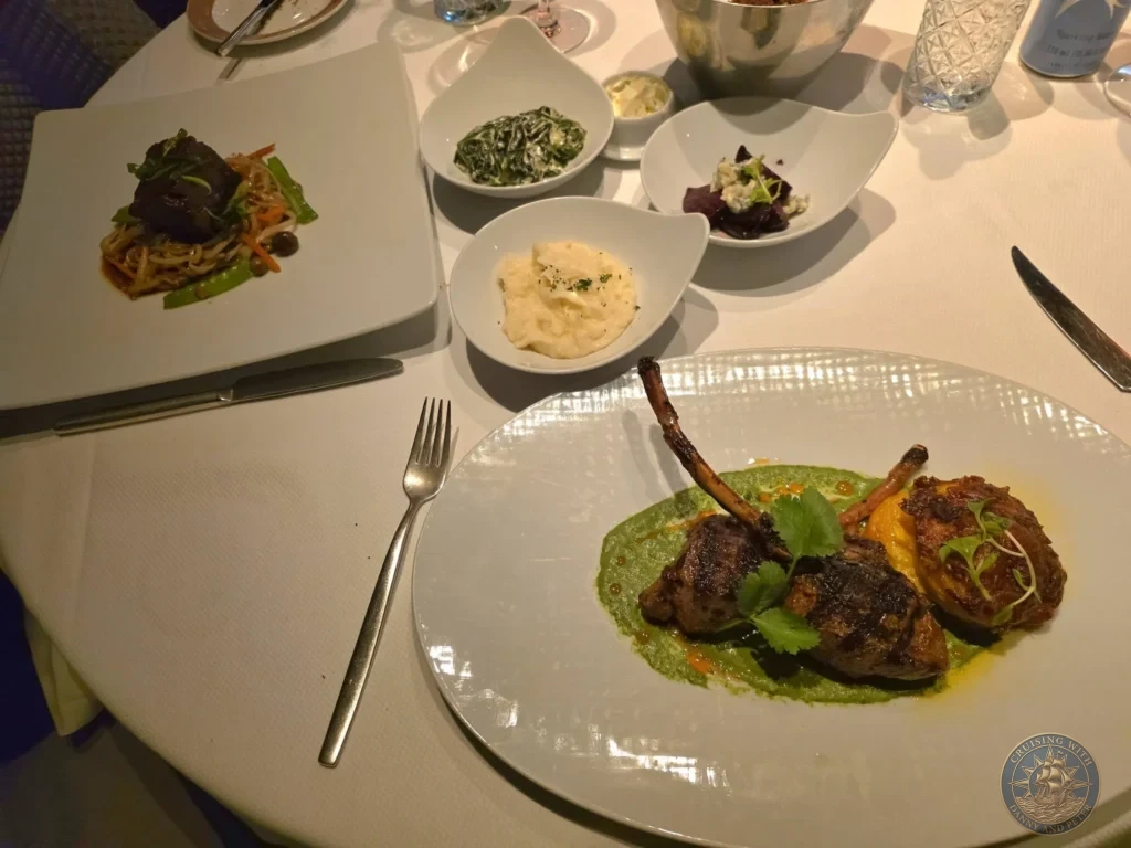 Plated lamb dish with mashed potatoes and sides at Pinnacle Grill on Holland America Westerdam in Kochi, Japan. Cruise ship gourmet dining. Kochi Cruise Port Guide | Things to do in Kochi from cruise ship | One day in Kochi Japan itinerary by Danny and Peter.