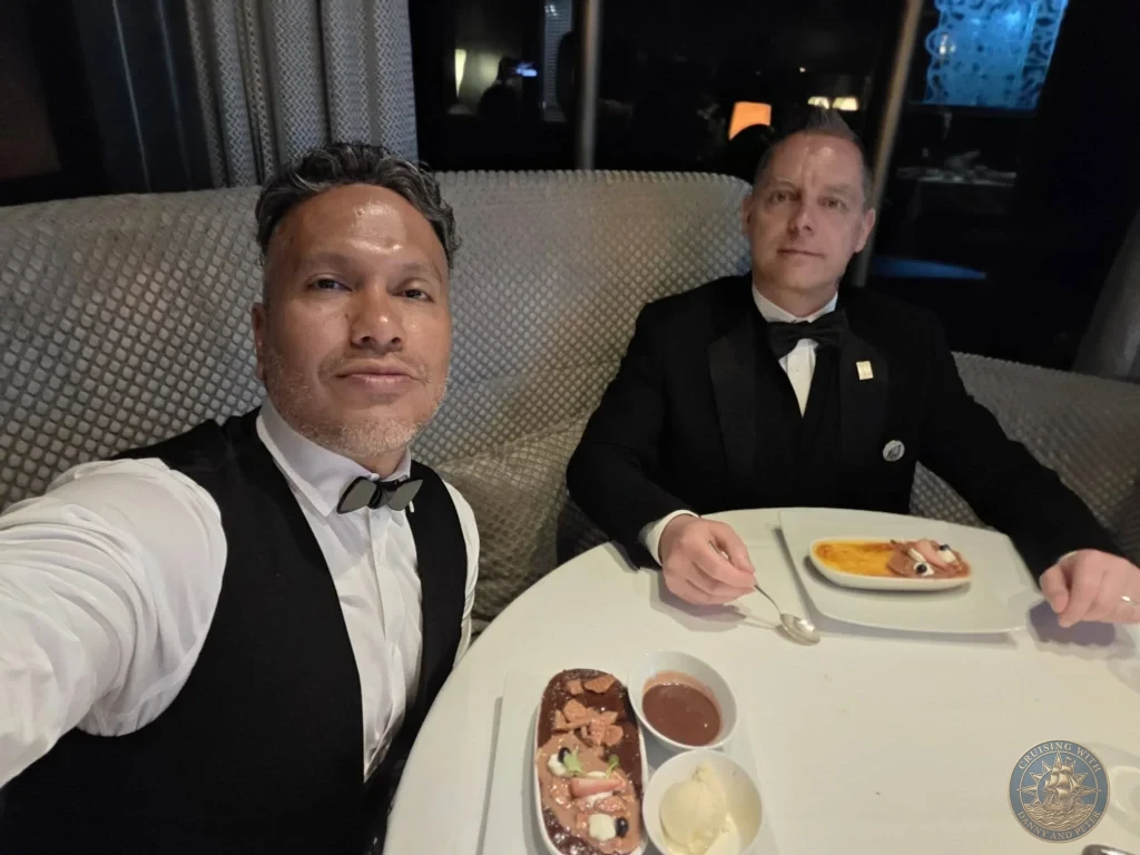 Danny and Peter seated with dessert course at Pinnacle Grill on Holland America Westerdam in Kochi, Japan. Cruise ship gourmet dining. Kochi Cruise Port Guide | Things to do in Kochi from cruise ship | One day in Kochi Japan itinerary by Danny and Peter.