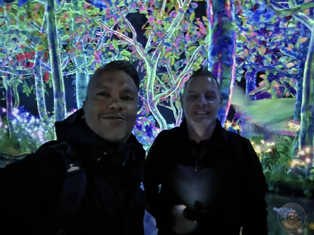 Danny and Peter taking a selfie in the colorful glowing forest installation at teamLab Forest Fukuoka, Japan. Immersive digital art. Fukuoka Cruise Port Guide | Things to do in Fukuoka from cruise ship | One day in Fukuoka Japan itinerary by Danny and Peter.