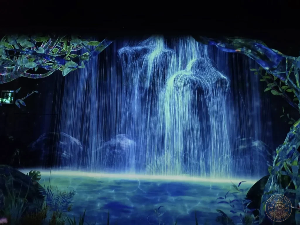 Luminous glowing waterfall in the immersive digital forest at teamLab Forest Fukuoka, Japan. teamLab art installation. Fukuoka Cruise Port Guide | Things to do in Fukuoka from cruise ship | One day in Fukuoka Japan itinerary by Danny and Peter.