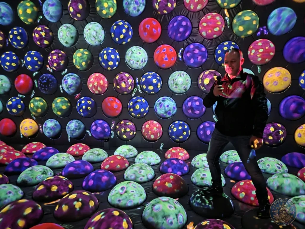 Peter standing among vibrant glowing interactive spheres at teamLab Forest Fukuoka, Japan. Immersive digital art experience. Fukuoka Cruise Port Guide | Things to do in Fukuoka from cruise ship | One day in Fukuoka Japan itinerary by Danny and Peter.