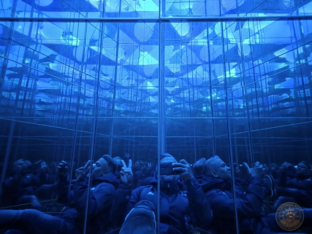 Visitors photographing infinite reflections in the mirror room with floating orbs at teamLab Forest Fukuoka, Japan. Immersive digital art installation. Fukuoka Cruise Port Guide | Things to do in Fukuoka from cruise ship | One day in Fukuoka Japan itinerary by Danny and Peter.