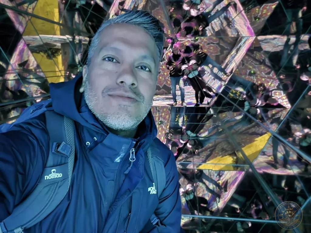 Danny taking a selfie in the infinite colorful mirror room at teamLab Forest Fukuoka, Japan. Immersive digital art experience. Fukuoka Cruise Port Guide | Things to do in Fukuoka from cruise ship | One day in Fukuoka Japan itinerary by Danny and Peter.