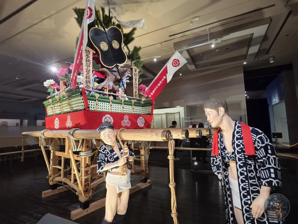 Detailed traditional Yamakasa float with mannequins in festival attire at Fukuoka City Museum, Japan. Cultural exhibit. Fukuoka Cruise Port Guide | Things to do in Fukuoka from cruise ship | One day in Fukuoka Japan itinerary by Danny and Peter.