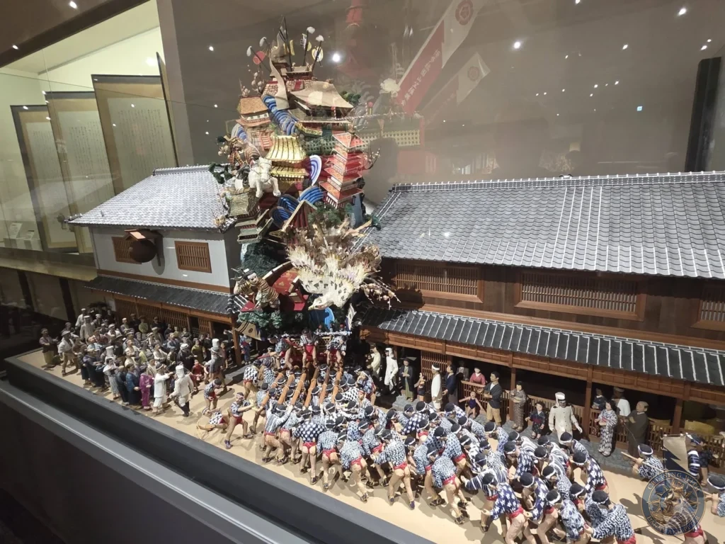 Detailed miniature diorama of Yamakasa festival carriers with ornate float at Fukuoka City Museum, Japan. Cultural heritage exhibit. Fukuoka Cruise Port Guide | Things to do in Fukuoka from cruise ship | One day in Fukuoka Japan itinerary by Danny and Peter.