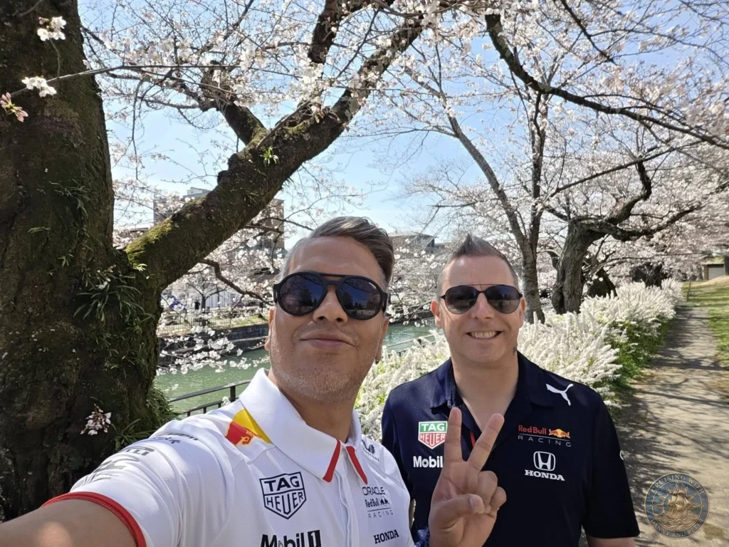 Kobe Japan Cruise Port Guide 2026 – Insider Tips & One Day Itinerary 50 Danny and Peter smiling in a selfie under cherry blossom trees by the canal near Heian Shrine in Kyoto, Japan. Spring day from Kobe. Kobe Japan Cruise Port Guide | DIY Kobe Cruise Port to City Center | Things to do in Kobe from cruise ship | Westerdam Kobe Docking Location | One day in Kobe Japan itinerary by Danny and Peter.