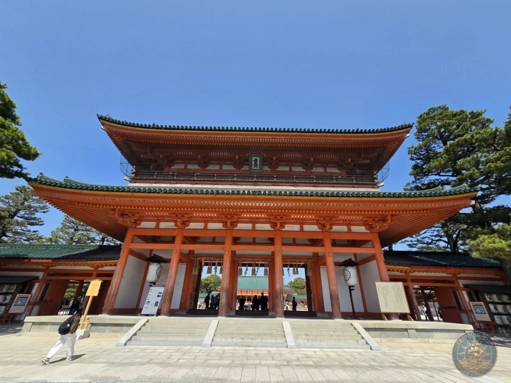Kobe Japan Cruise Port Guide 2026 – Insider Tips & One Day Itinerary 41 Front view of the large red and green Otenmon gate of Heian Shrine under a clear blue sky in Kyoto, Japan. Iconic shrine entrance from Kobe port day. Kobe Japan Cruise Port Guide | DIY Kobe Cruise Port to City Center | Things to do in Kobe from cruise ship | Westerdam Kobe Docking Location | One day in Kobe Japan itinerary by Danny and Peter.