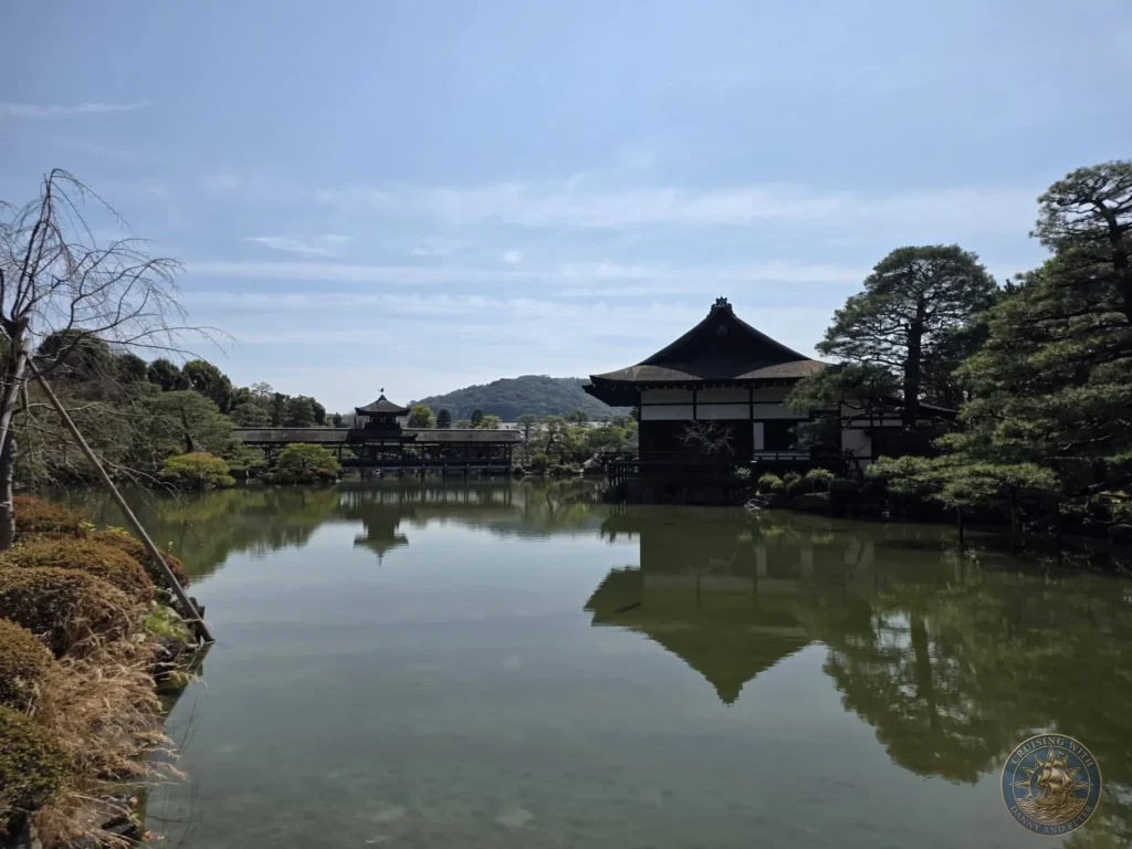 Kobe Japan Cruise Port Guide 2026 – Insider Tips & One Day Itinerary 59 Scenic pond with reflections of traditional buildings and trees at Heian Shrine under a blue sky in Kyoto, Japan. Beautiful shrine gardens from Kobe port day. Kobe Japan Cruise Port Guide | DIY Kobe Cruise Port to City Center | Things to do in Kobe from cruise ship | Westerdam Kobe Docking Location | One day in Kobe Japan itinerary by Danny and Peter.