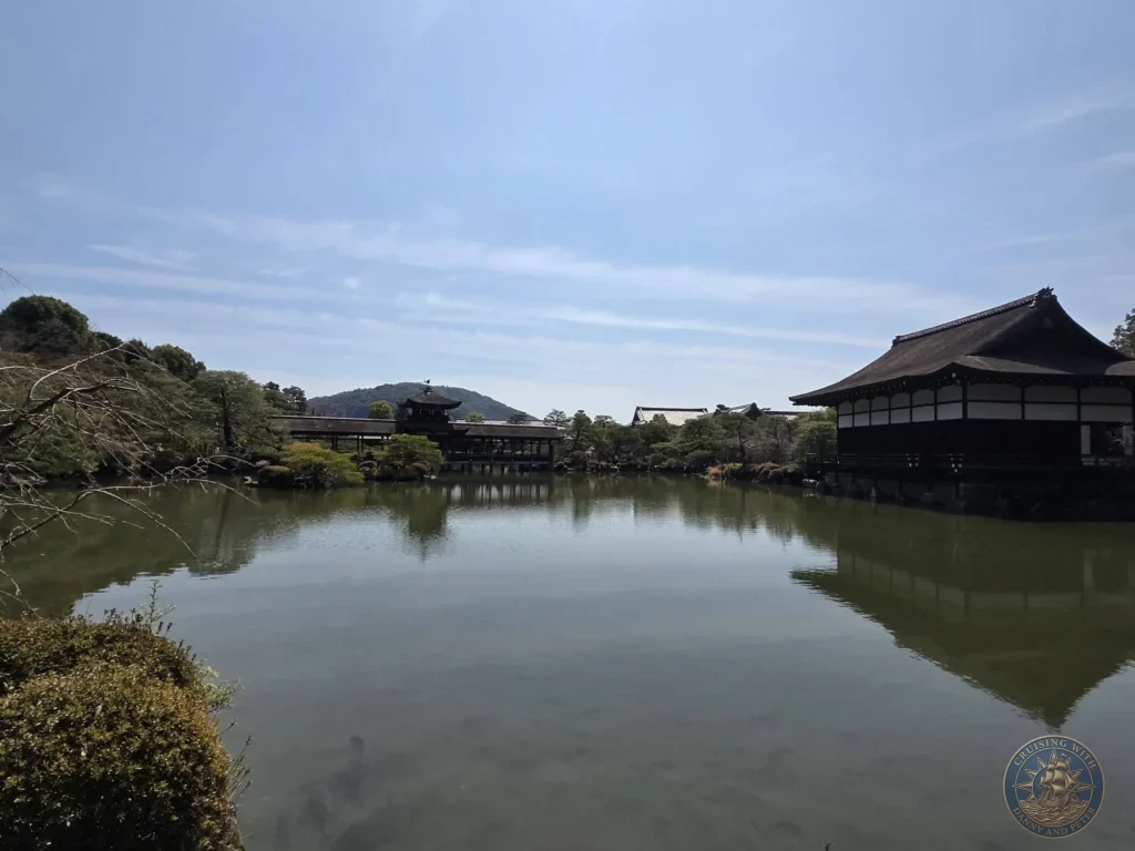 Kobe Japan Cruise Port Guide 2026 – Insider Tips & One Day Itinerary 61 Wide view of the pond with reflections of traditional buildings and trees at Heian Shrine under a blue sky in Kyoto, Japan. Peaceful shrine gardens from Kobe port day. Kobe Japan Cruise Port Guide | DIY Kobe Cruise Port to City Center | Things to do in Kobe from cruise ship | Westerdam Kobe Docking Location | One day in Kobe Japan itinerary by Danny and Peter.