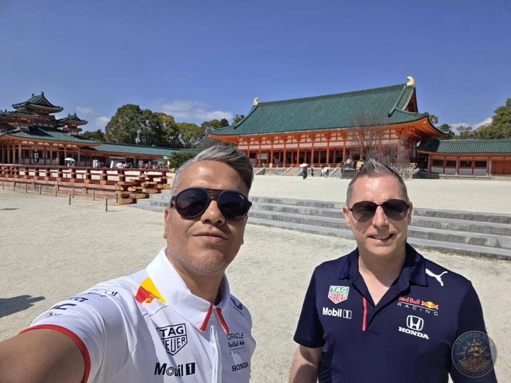 Kobe Japan Cruise Port Guide 2026 – Insider Tips & One Day Itinerary 65 Danny and Peter taking a selfie in the main courtyard of Heian Shrine with the large red and green traditional buildings under a clear blue sky in Kyoto, Japan. Iconic shrine architecture from Kobe port day. Kobe Japan Cruise Port Guide | DIY Kobe Cruise Port to City Center | Things to do in Kobe from cruise ship | Westerdam Kobe Docking Location | One day in Kobe Japan itinerary by Danny and Peter.