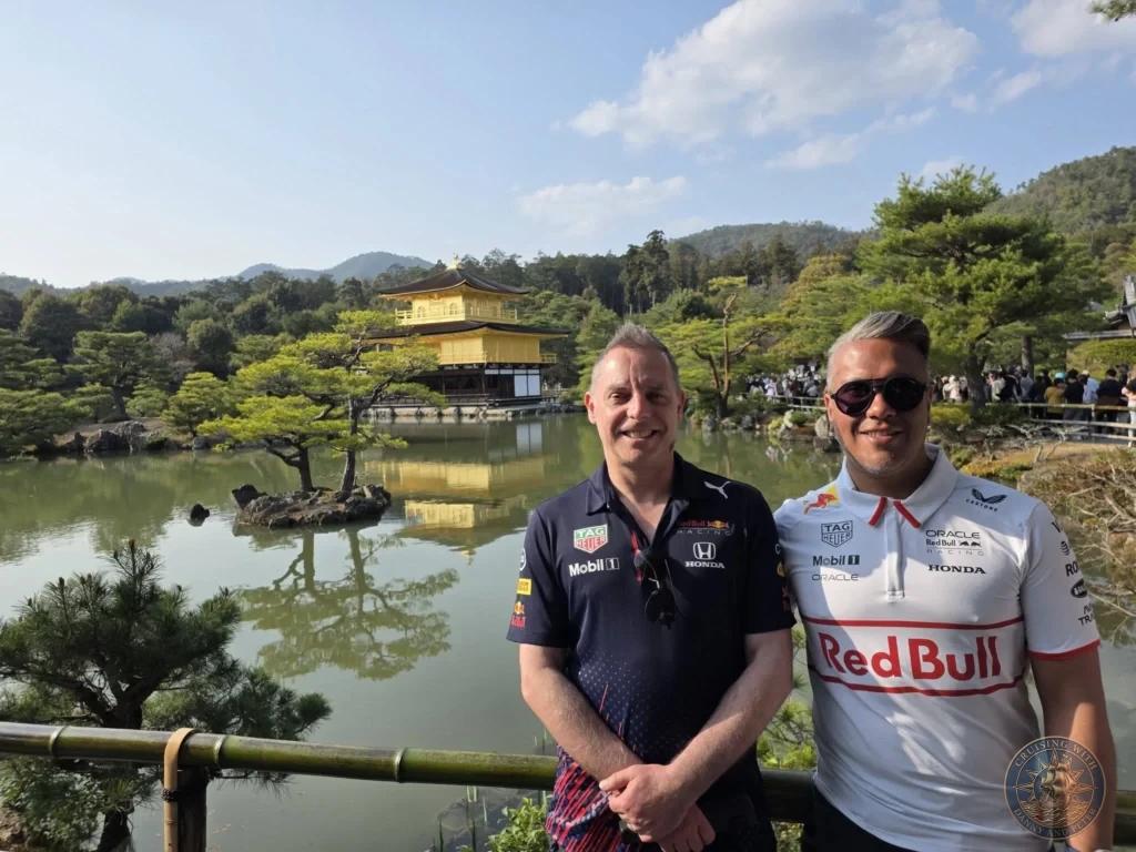 Kobe Japan Cruise Port Guide 2026 – Insider Tips & One Day Itinerary 14 Danny and Peter smiling in front of the Golden Pavilion (Kinkaku-ji) reflecting in the pond in Kyoto, Japan. Iconic temple visit from Kobe. Kobe Japan Cruise Port Guide | DIY Kobe Cruise Port to City Center | Things to do in Kobe from cruise ship | Westerdam Kobe Docking Location | One day in Kobe Japan itinerary by Danny and Peter.