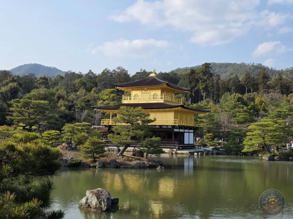 Kobe Japan Cruise Port Guide 2026 – Insider Tips & One Day Itinerary 10 The Golden Pavilion (Kinkaku-ji) reflecting in the pond surrounded by pine trees and hills in Kyoto, Japan. Iconic temple from Kobe port day. Kobe Japan Cruise Port Guide | DIY Kobe Cruise Port to City Center | Things to do in Kobe from cruise ship | Westerdam Kobe Docking Location | One day in Kobe Japan itinerary by Danny and Peter.