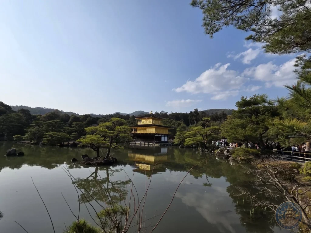 Kobe Japan Cruise Port Guide 2026 – Insider Tips & One Day Itinerary 149 Golden Pavilion of Kinkaku-ji reflecting in the calm pond surrounded by pine trees and hills in Kyoto, Japan. Temple view from Kobe port day. Kobe Japan Cruise Port Guide | DIY Kobe Cruise Port to City Center | Things to do in Kobe from cruise ship | Westerdam Kobe Docking Location | One day in Kobe Japan itinerary by Danny and Peter.