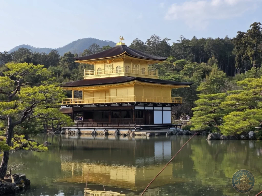 Kobe Japan Cruise Port Guide 2026 – Insider Tips & One Day Itinerary 3 Close-up view of the Golden Pavilion (Kinkaku-ji) reflecting in the pond with pine trees and forested hills in Kyoto, Japan. Temple highlight from Kobe. Kobe Japan Cruise Port Guide | DIY Kobe Cruise Port to City Center | Things to do in Kobe from cruise ship | Westerdam Kobe Docking Location | One day in Kobe Japan itinerary by Danny and Peter.