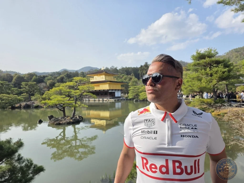 Kobe Japan Cruise Port Guide 2026 – Insider Tips & One Day Itinerary 143 Danny posing in front of the Golden Pavilion (Kinkaku-ji) reflecting in the pond in Kyoto, Japan. Temple visit from Kobe cruise port. Kobe Japan Cruise Port Guide | DIY Kobe Cruise Port to City Center | Things to do in Kobe from cruise ship | Westerdam Kobe Docking Location | One day in Kobe Japan itinerary by Danny and Peter.