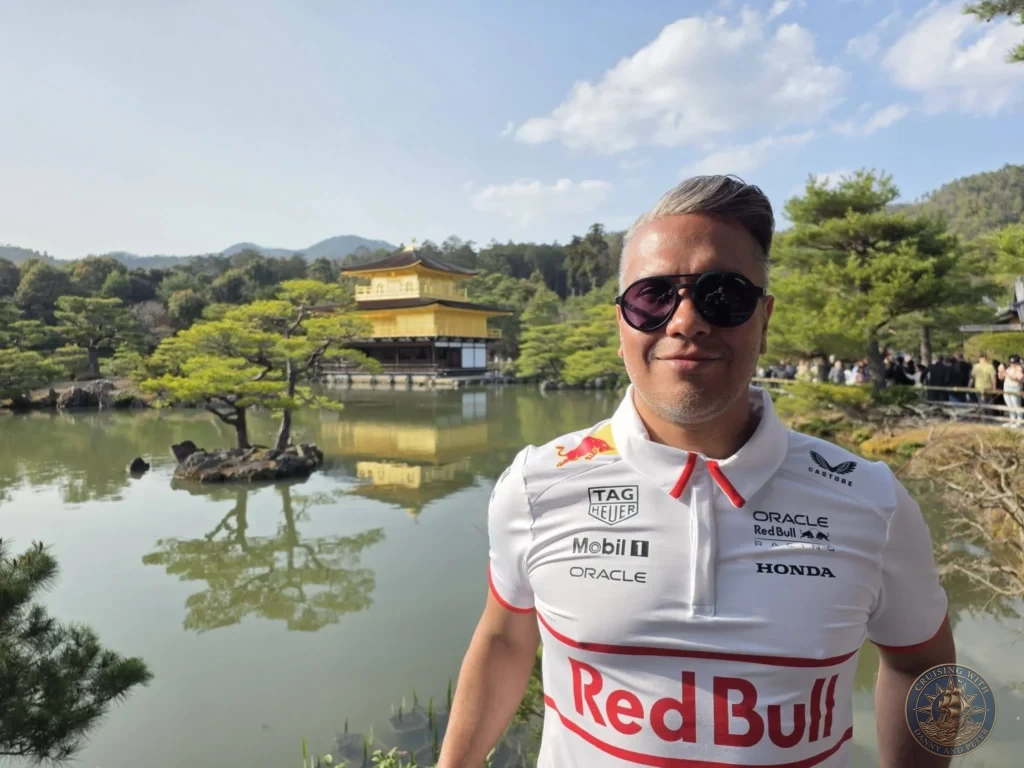 Kobe Japan Cruise Port Guide 2026 – Insider Tips & One Day Itinerary 155 Danny posing in front of the Golden Pavilion (Kinkaku-ji) reflecting in the pond in Kyoto, Japan. Temple highlight from Kobe cruise port. Kobe Japan Cruise Port Guide | DIY Kobe Cruise Port to City Center | Things to do in Kobe from cruise ship | Westerdam Kobe Docking Location | One day in Kobe Japan itinerary by Danny and Peter.