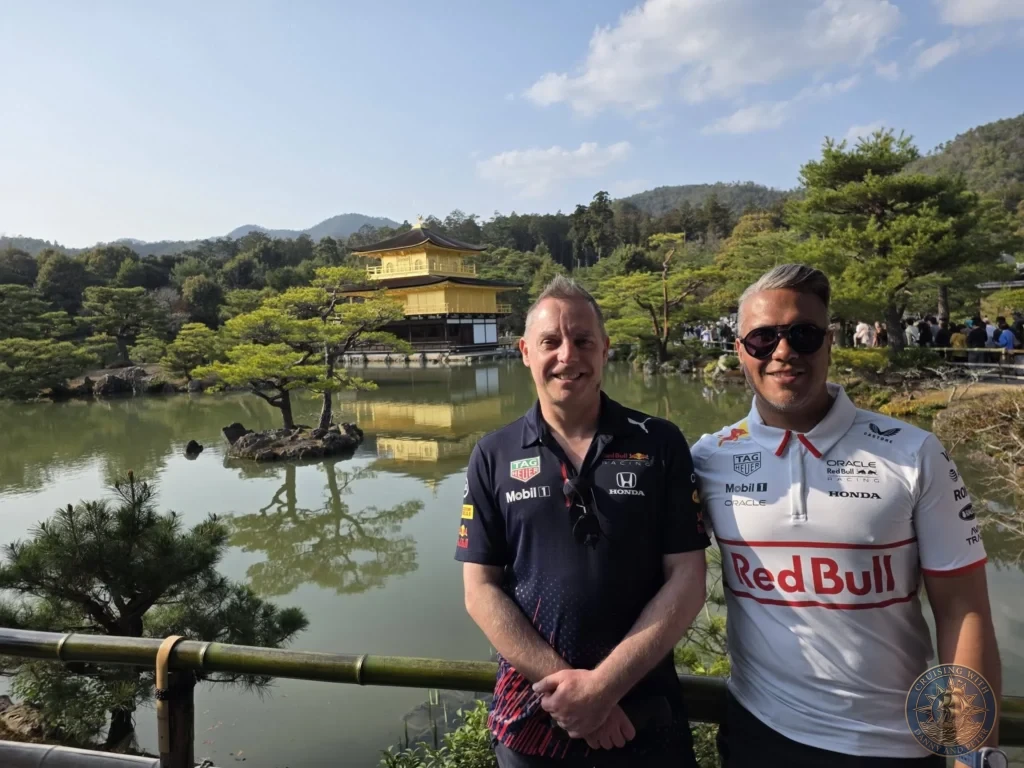 Kobe Japan Cruise Port Guide 2026 – Insider Tips & One Day Itinerary 42 Danny and Peter posing together in front of the Golden Pavilion (Kinkaku-ji) reflecting in the pond in Kyoto, Japan. Temple visit from Kobe cruise port. Kobe Japan Cruise Port Guide | DIY Kobe Cruise Port to City Center | Things to do in Kobe from cruise ship | Westerdam Kobe Docking Location | One day in Kobe Japan itinerary by Danny and Peter.