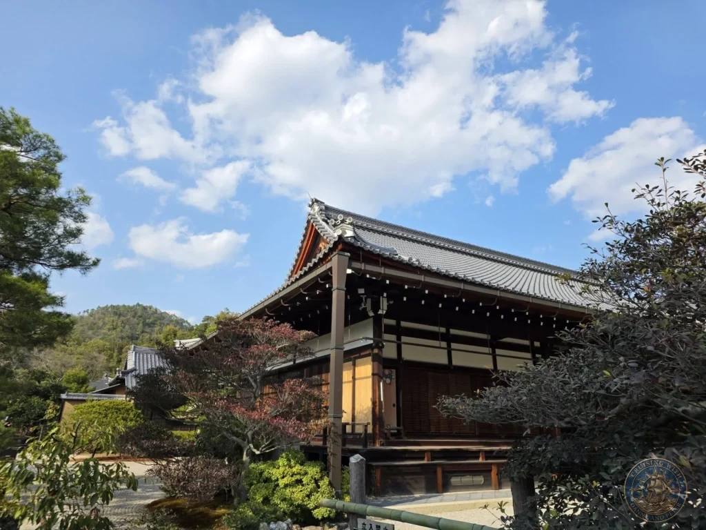 Kobe Japan Cruise Port Guide 2026 – Insider Tips & One Day Itinerary 68 Traditional Japanese temple building with tiled roof at Kinkaku-ji under a blue sky with clouds in Kyoto, Japan. Temple grounds from Kobe port day. Kobe Japan Cruise Port Guide | DIY Kobe Cruise Port to City Center | Things to do in Kobe from cruise ship | Westerdam Kobe Docking Location | One day in Kobe Japan itinerary by Danny and Peter.