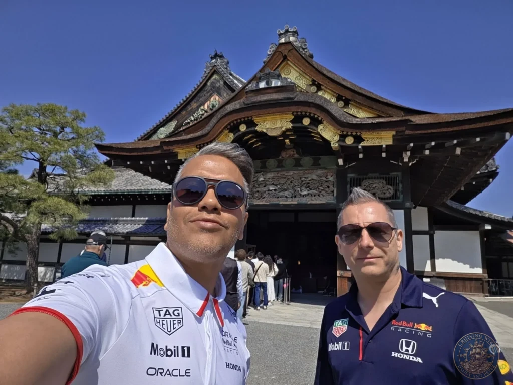 Kobe Japan Cruise Port Guide 2026 – Insider Tips & One Day Itinerary 4 Danny and Peter taking a selfie in front of the ornate entrance gate of Nijo Castle in Kyoto, Japan. Historic site visit from Kobe. Kobe Japan Cruise Port Guide | DIY Kobe Cruise Port to City Center | Things to do in Kobe from cruise ship | Westerdam Kobe Docking Location | One day in Kobe Japan itinerary by Danny and Peter.