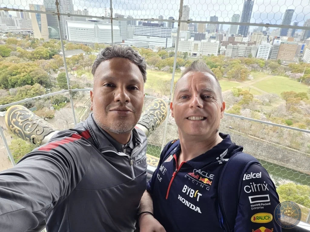 Kobe Japan Cruise Port Guide 2026 – Insider Tips & One Day Itinerary 112 Danny and Peter taking a selfie at the top of Osaka Castle with golden roof ornaments, park grounds and the city skyline behind them in Osaka, Japan. Summit view from Kobe port day. Kobe Japan Cruise Port Guide | DIY Kobe Cruise Port to City Center | Things to do in Kobe from cruise ship | Westerdam Kobe Docking Location | One day in Kobe Japan itinerary by Danny and Peter.